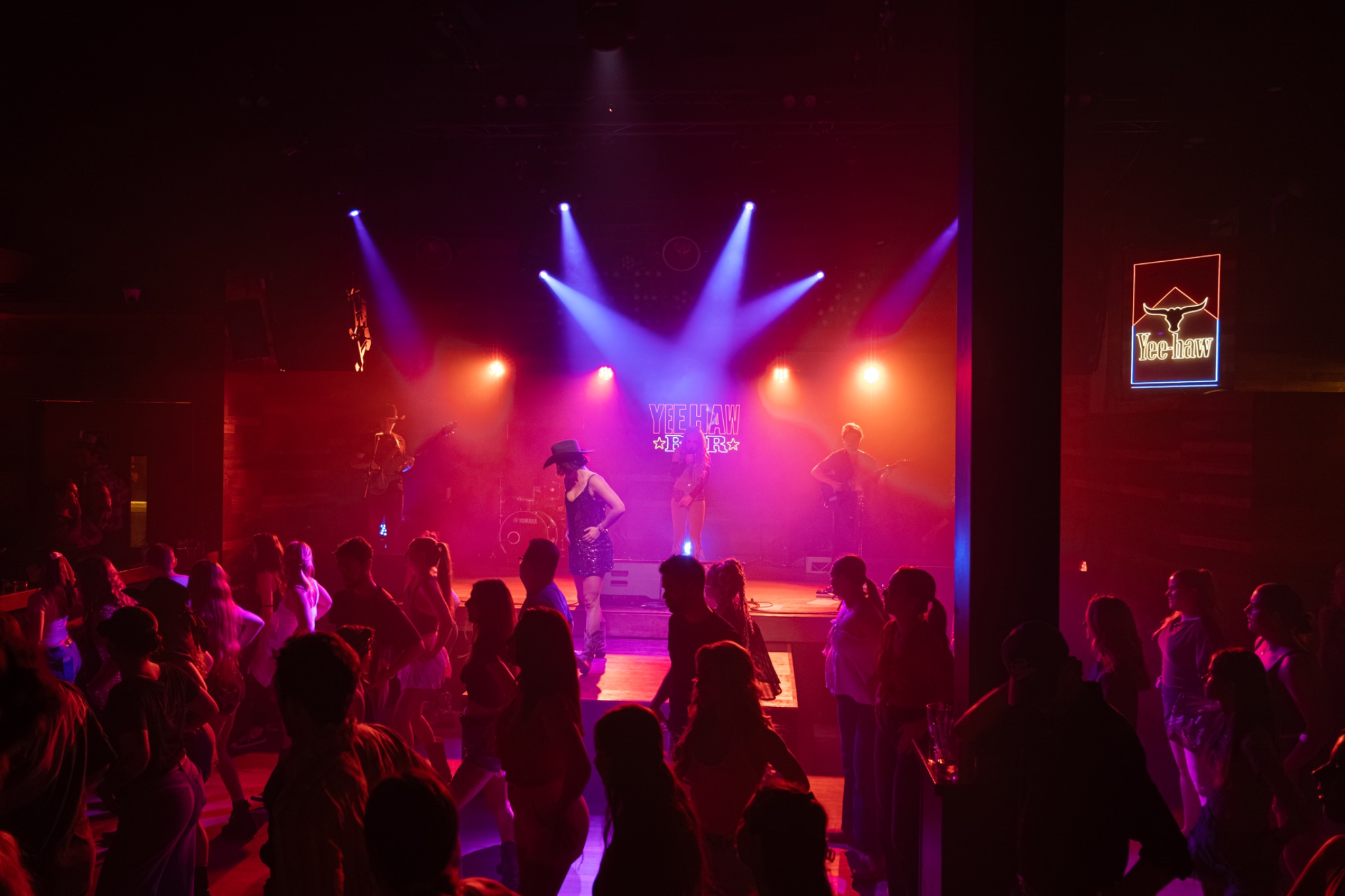 Live band and dancers sharing the Yeehaw floor